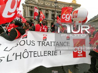 French General Confederation of Labour (CGT) unionists hold a banner reading "no to subcontracting in hotel industry" as they gather in fron...