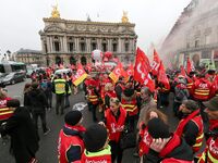 French General Confederation of Labour (CGT) unionists gather in front of Paris' Opera Garnier on December 20, 2017, to protest against Fren...