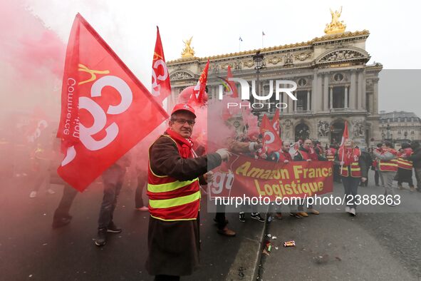 French General Confederation of Labour (CGT) unionists hold smoke canisters as they gather in front of Paris' Opera Garnier on December 20,...