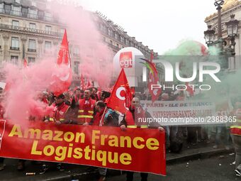 French General Confederation of Labour (CGT) unionists hold smoke canisters as they gather in front of Paris' Opera Garnier on December 20,...