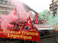 French General Confederation of Labour (CGT) unionists hold smoke canisters as they gather in front of Paris' Opera Garnier on December 20,...