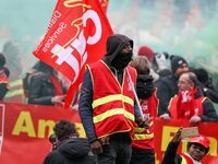 French General Confederation of Labour (CGT) unionists gather in front of Paris' Opera Garnier on December 20, 2017, to protest against Fren...