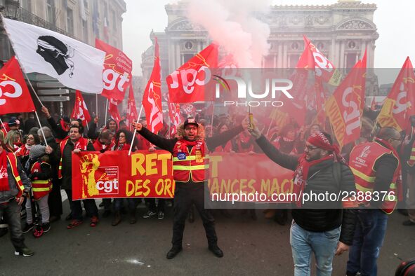 People hold a banner reading "withdrawal of Macron's executive orders" during a demonstration called by French General Confederation of Labo...