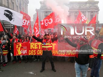 People hold a banner reading "withdrawal of Macron's executive orders" during a demonstration called by French General Confederation of Labo...