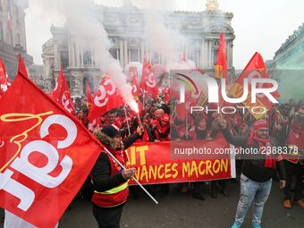 People hold a banner reading "withdrawal of Macron's executive orders" during a demonstration called by French General Confederation of Labo...