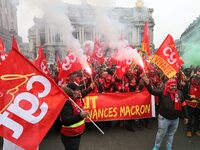 People hold a banner reading "withdrawal of Macron's executive orders" during a demonstration called by French General Confederation of Labo...