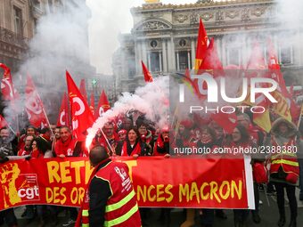 People hold a banner reading "withdrawal of Macron's executive orders" during a demonstration called by French General Confederation of Labo...