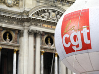 French General Confederation of Labour (CGT) unionists gather in front of Paris' Opera Garnier on December 20, 2017, to protest against Fren...