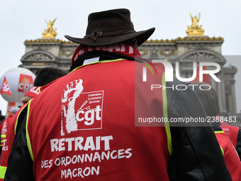 French General Confederation of Labour (CGT) unionists gather in front of Paris' Opera Garnier on December 20, 2017, to protest against Fren...