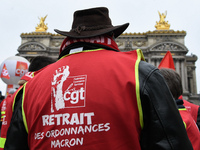 French General Confederation of Labour (CGT) unionists gather in front of Paris' Opera Garnier on December 20, 2017, to protest against Fren...