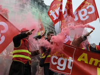 French General Confederation of Labour (CGT) unionists gather in front of Paris' Opera Garnier on December 20, 2017, to protest against Fren...