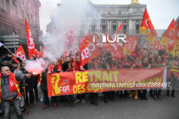 People hold a banner reading "withdrawal of Macron's executive orders" during a demonstration called by French General Confederation of Labo...