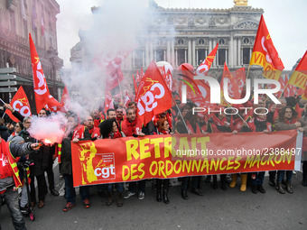 People hold a banner reading "withdrawal of Macron's executive orders" during a demonstration called by French General Confederation of Labo...