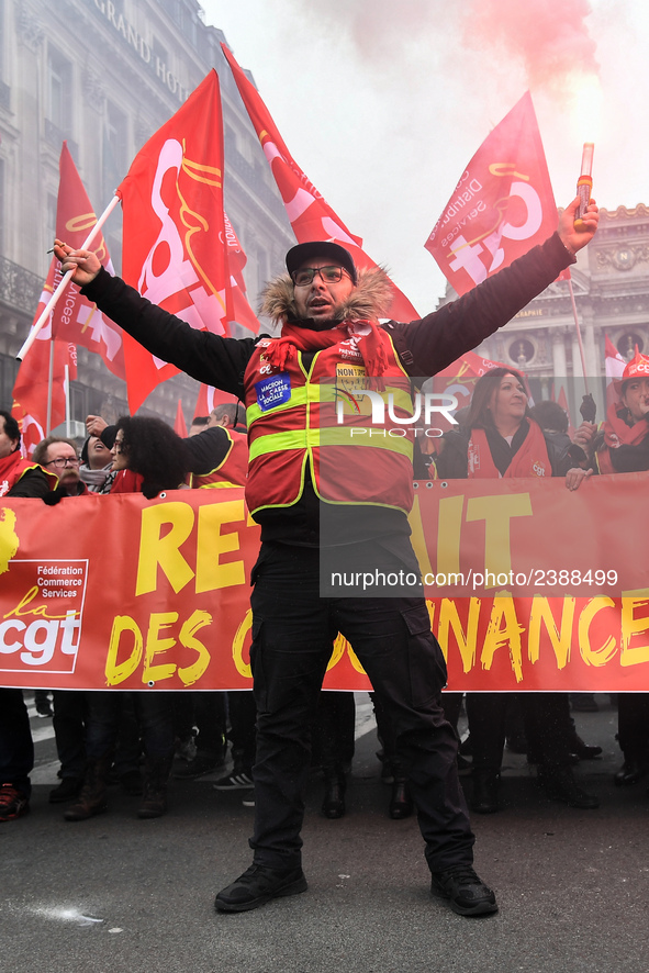 People hold a banner reading "withdrawal of Macron's executive orders" during a demonstration called by French General Confederation of Labo...