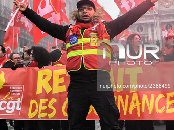 People hold a banner reading "withdrawal of Macron's executive orders" during a demonstration called by French General Confederation of Labo...