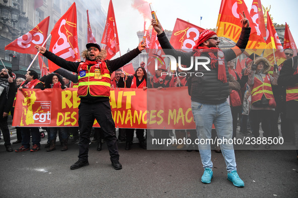 People hold a banner reading "withdrawal of Macron's executive orders" during a demonstration called by French General Confederation of Labo...