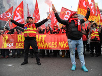 People hold a banner reading "withdrawal of Macron's executive orders" during a demonstration called by French General Confederation of Labo...