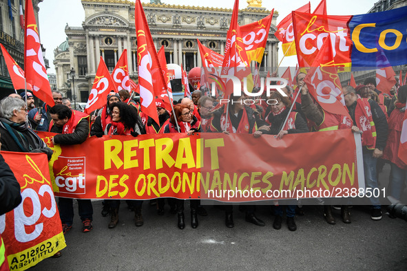 People hold a banner reading "withdrawal of Macron's executive orders" during a demonstration called by French General Confederation of Labo...