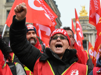 French General Confederation of Labour (CGT) unionists gather in front of Paris' Opera Garnier on December 20, 2017, to protest against Fren...