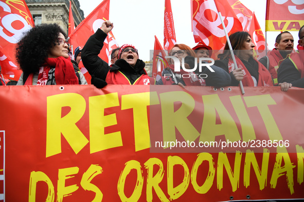 People hold a banner reading "withdrawal of Macron's executive orders" during a demonstration called by French General Confederation of Labo...