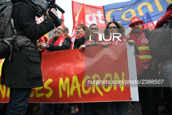 People hold a banner reading "withdrawal of Macron's executive orders" during a demonstration called by French General Confederation of Labo...