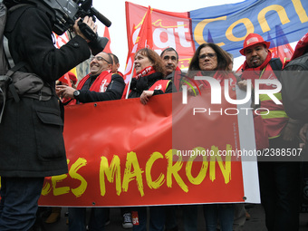 People hold a banner reading "withdrawal of Macron's executive orders" during a demonstration called by French General Confederation of Labo...