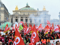 French General Confederation of Labour (CGT) unionists gather in front of Paris' Opera Garnier on December 20, 2017, to protest against Fren...