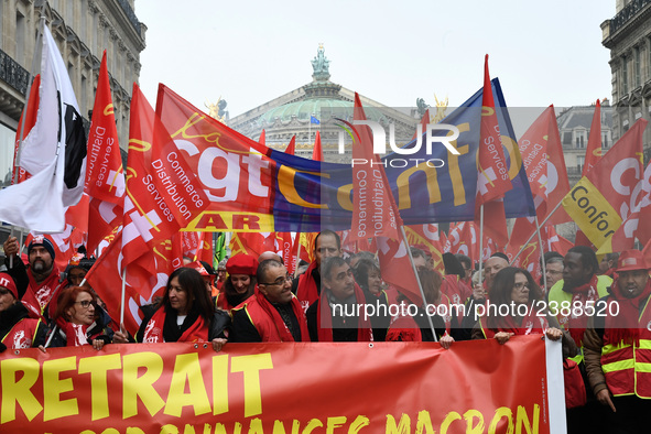 People hold a banner reading "withdrawal of Macron's executive orders" during a demonstration called by French General Confederation of Labo...