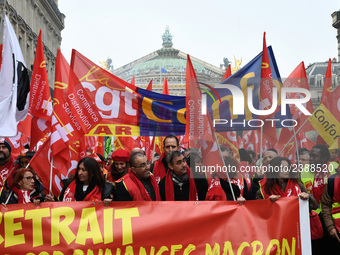 People hold a banner reading "withdrawal of Macron's executive orders" during a demonstration called by French General Confederation of Labo...