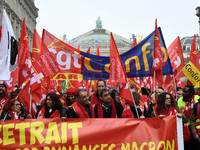 People hold a banner reading "withdrawal of Macron's executive orders" during a demonstration called by French General Confederation of Labo...