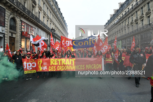 People hold a banner reading "withdrawal of Macron's executive orders" during a demonstration called by French General Confederation of Labo...