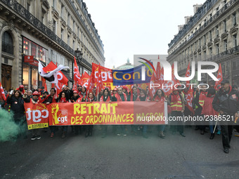 People hold a banner reading "withdrawal of Macron's executive orders" during a demonstration called by French General Confederation of Labo...