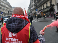 French General Confederation of Labour (CGT) unionists gather in front of Paris' Opera Garnier on December 20, 2017, to protest against Fren...