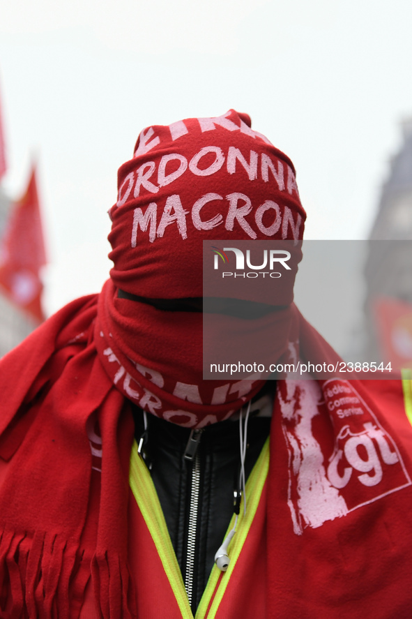 A man march through the streets of Paris during a demonstration called by French General Confederation of Labour (CGT) union on December 20,...