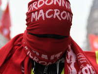 A man march through the streets of Paris during a demonstration called by French General Confederation of Labour (CGT) union on December 20,...