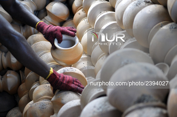 A pottery maker take out the clay pottery from the burning section in Kuala Selangor, Malaysia .  