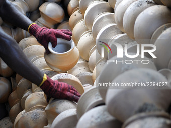 A pottery maker take out the clay pottery from the burning section in Kuala Selangor, Malaysia .  (