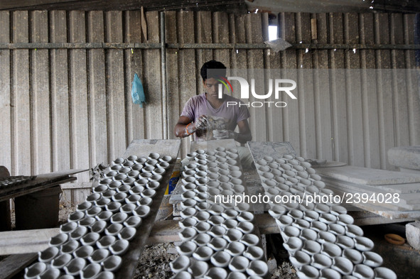 A pottery maker produces a clay lantern or ‘diya’ in Kuala Selangor, Malaysia. Diyas are the small earthen lamps primarily used during Diwal...