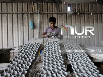 A pottery maker produces a clay lantern or ‘diya’ in Kuala Selangor, Malaysia. Diyas are the small earthen lamps primarily used during Diwal...