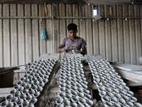 A pottery maker produces a clay lantern or ‘diya’ in Kuala Selangor, Malaysia. Diyas are the small earthen lamps primarily used during Diwal...