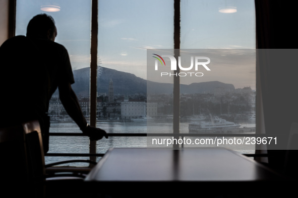 A pilgrim inside a cruise ship sees the city of Split, Croatia. Many italian pilgrims travel via cruise ship from Ancona, Italy to Split, Cr...