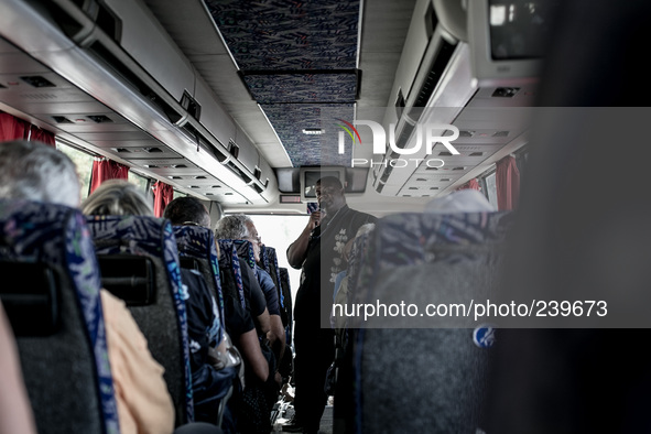 Don Gaetano, an italian priest, inside the bus on the road to Medjugorje talks with pilgrims and prays during the pilgrimage to Medjugorje....