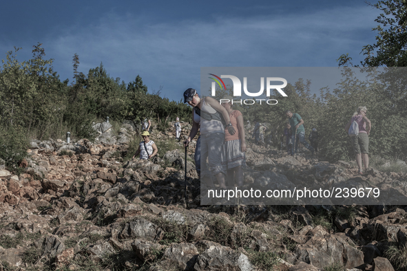 Pilgrims on a steep path that leads on the very place of the apparitions of Our Lady,  called Podbrdo and Apparition Hill. Almost one millio...