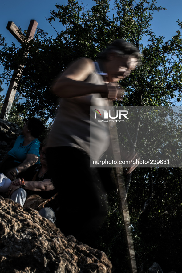 Pilgrims on a steep path that leads on the very place of the apparitions of Our Lady,  called Podbrdo and Apparition Hill. Almost one millio...