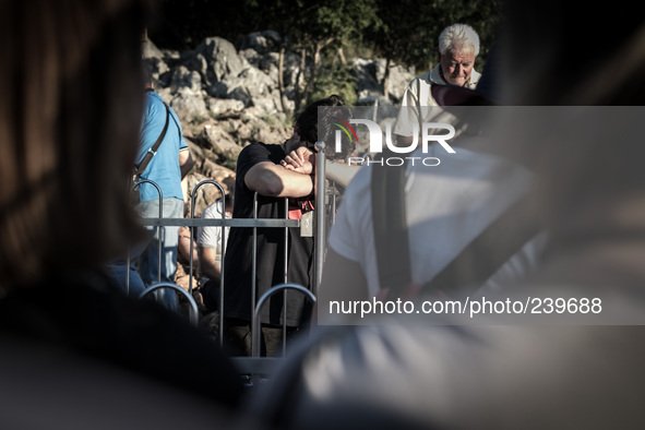 A pilgrim near the statue of Virgin Mary on the the Apparition Hill, in Medjugorje. Almost one million people visit Medjugorje each year, wh...