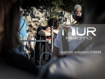 A pilgrim near the statue of Virgin Mary on the the Apparition Hill, in Medjugorje. Almost one million people visit Medjugorje each year, wh...