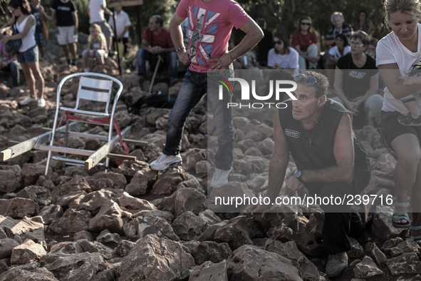 A pilgrim prays in front of statue of Virgin Mary on the the Apparition Hill, in Medjugorje. Almost one million people visit Medjugorje each...