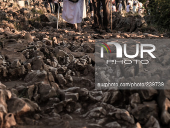 A man help a nun on a steep path that leads on the very place of the apparitions of Our Lady,  called Podbrdo and Apparition Hill.Almost one...