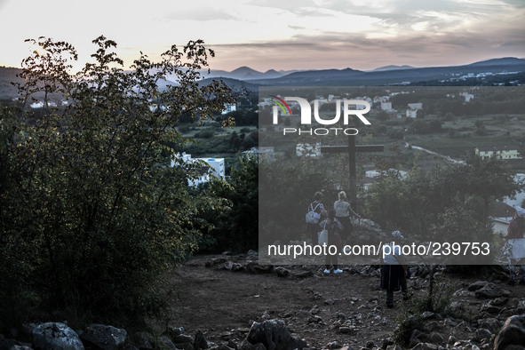 A cross on a steep path that leads on the very place of the apparitions of Our Lady, called Podbrdo and Apparition Hill. On the way towards...