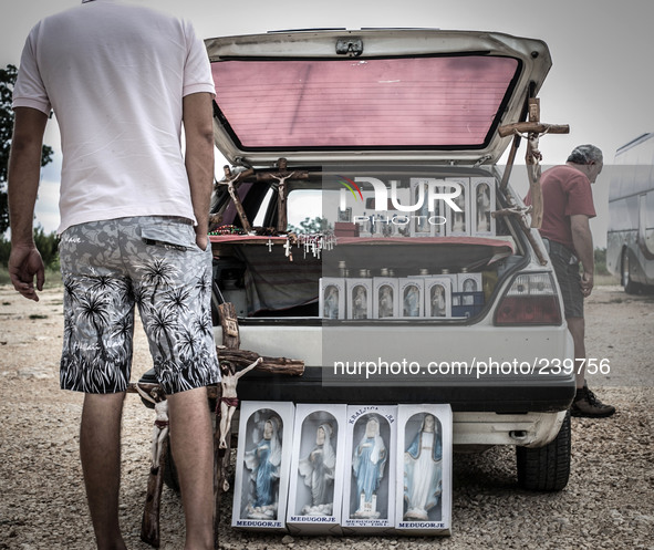 A man show on his car the Virgin Mary statues, rosaries, crucifixes for sell to tourist in Medjugorje. Almost one million people visit Medju...